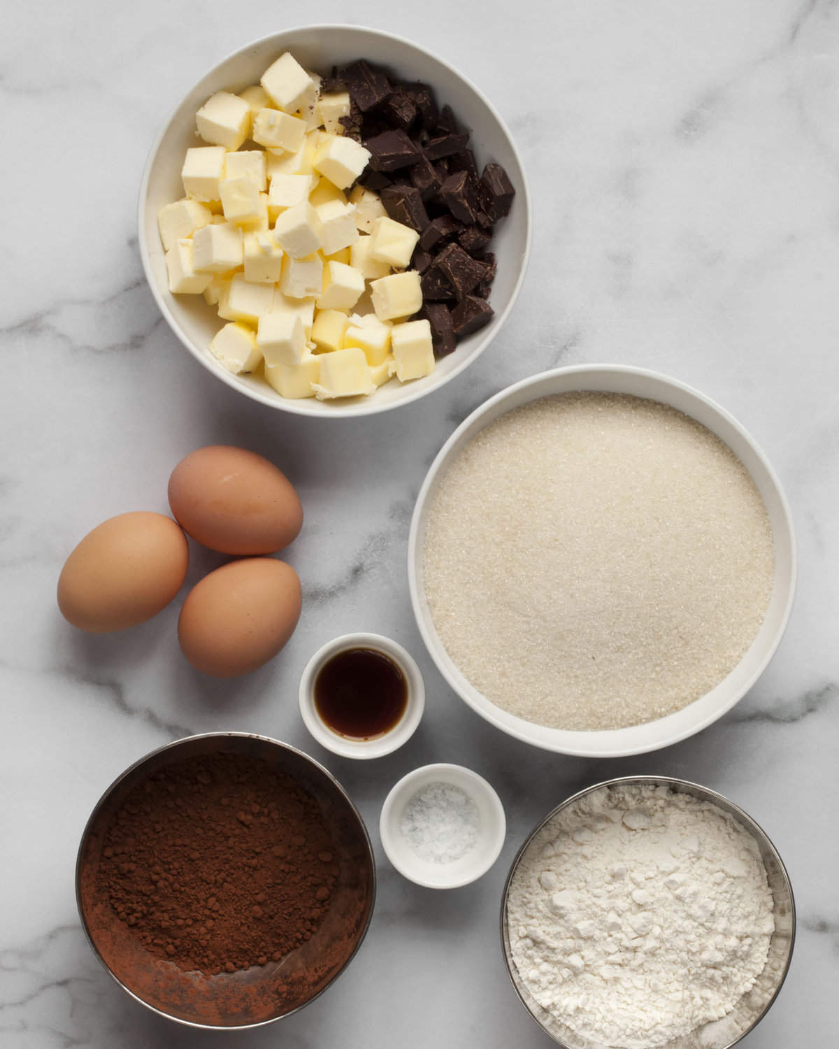 Ingredients including chocolate, butter, sugar, cocoa powder, eggs, flour and vanilla extract.