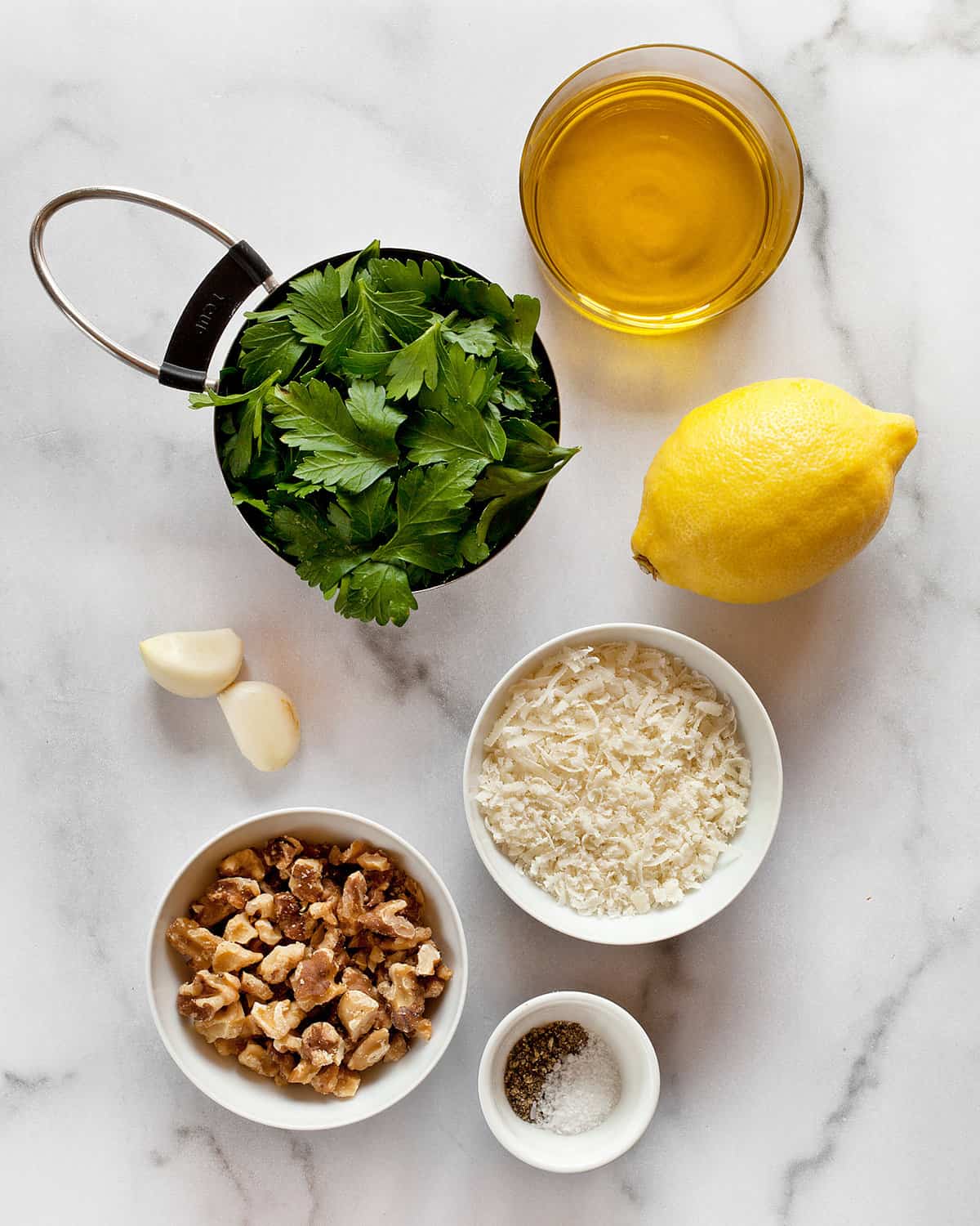 Ingredients including parsley, Parmesan, walnuts, lemon, garlic, olive oil, salt and pepper.