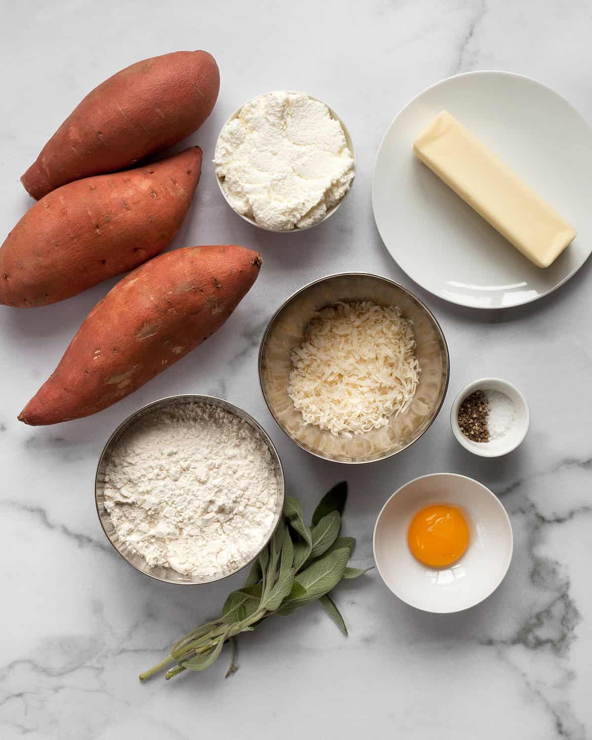 Ingredients including sweet potatoes, Parmesan, ricotta, flour, egg yolk, flour, sage, butter, salt and pepper.