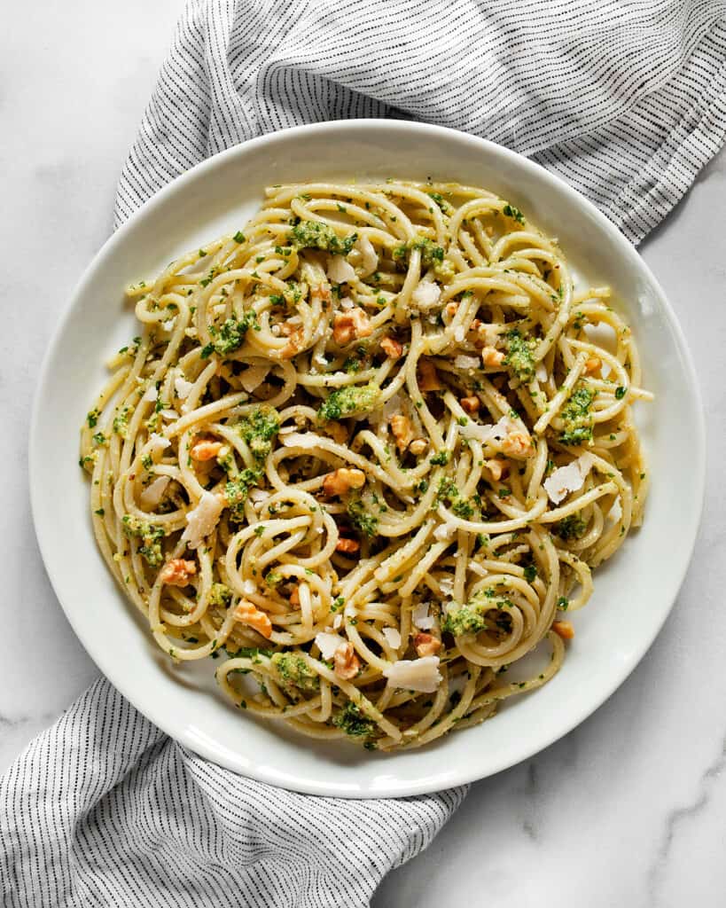 Spaghetti with parsley pesto on a plate.
