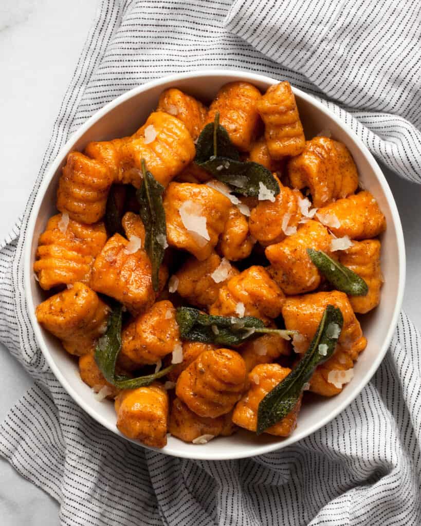 Sweet potato gnocchi with crispy sage in a bowl.
