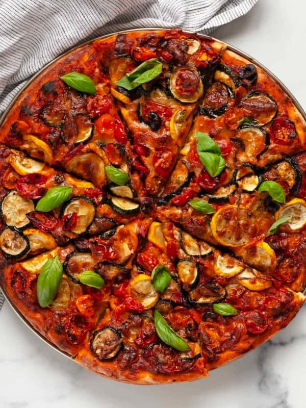 Sliced roasted veggie pizza.