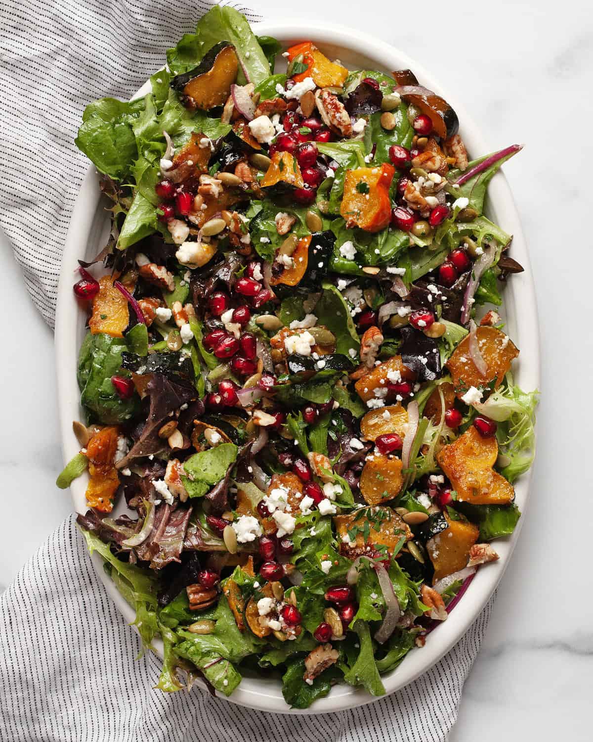 Roasted squash salad on an oval serving platter.