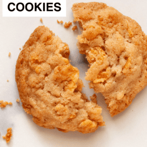 One cornflake cookie broken in half.