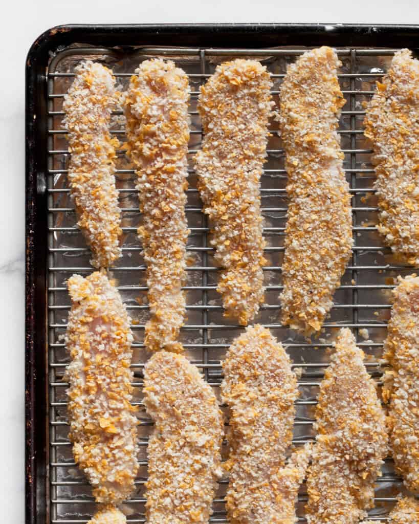 Unbaked chicken tenders on a rack