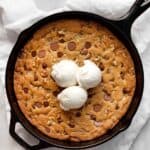 Chocolate Chip Walnut Skillet Cookie topped with ice cream