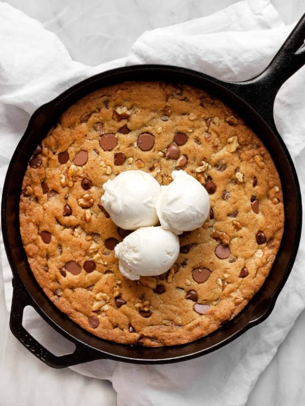 Chocolate Chip Walnut Skillet Cookie topped with ice cream