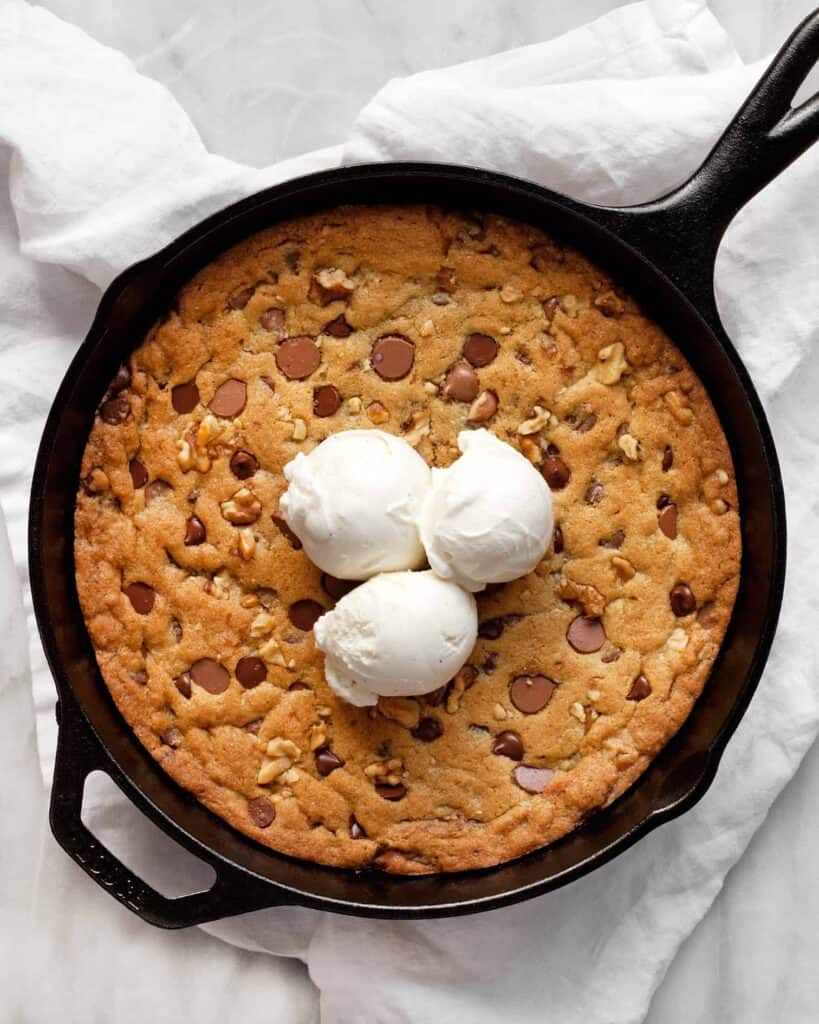 Chocolate Chip Walnut Skillet Cookie topped with ice cream