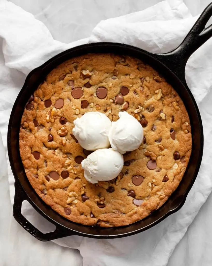 Chocolate Chip Walnut Skillet Cookie topped with ice cream