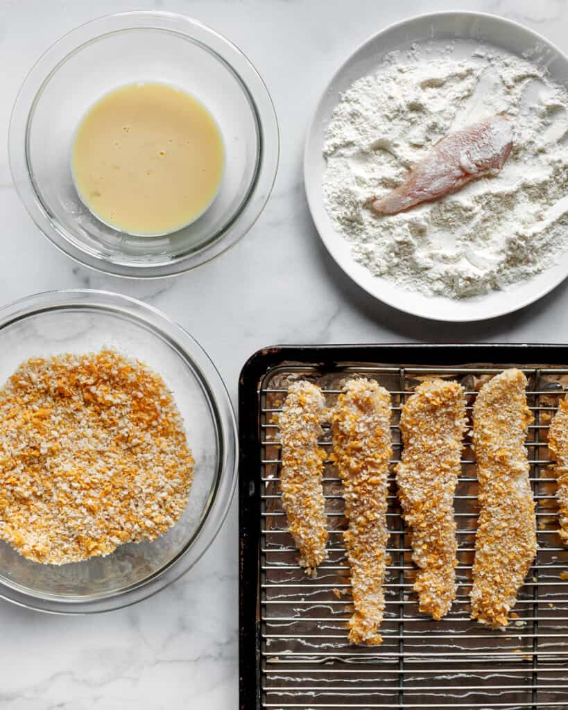 To assemble the tenders, dredge the chicken in flour, dip it into the egg mixture and coat it in cornflake-panko breading