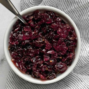 Onion jam in a bowl with a spoon.