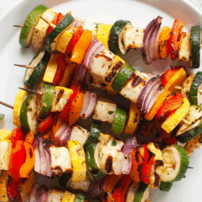 Grilled halloumi veggie skewers on a plate.