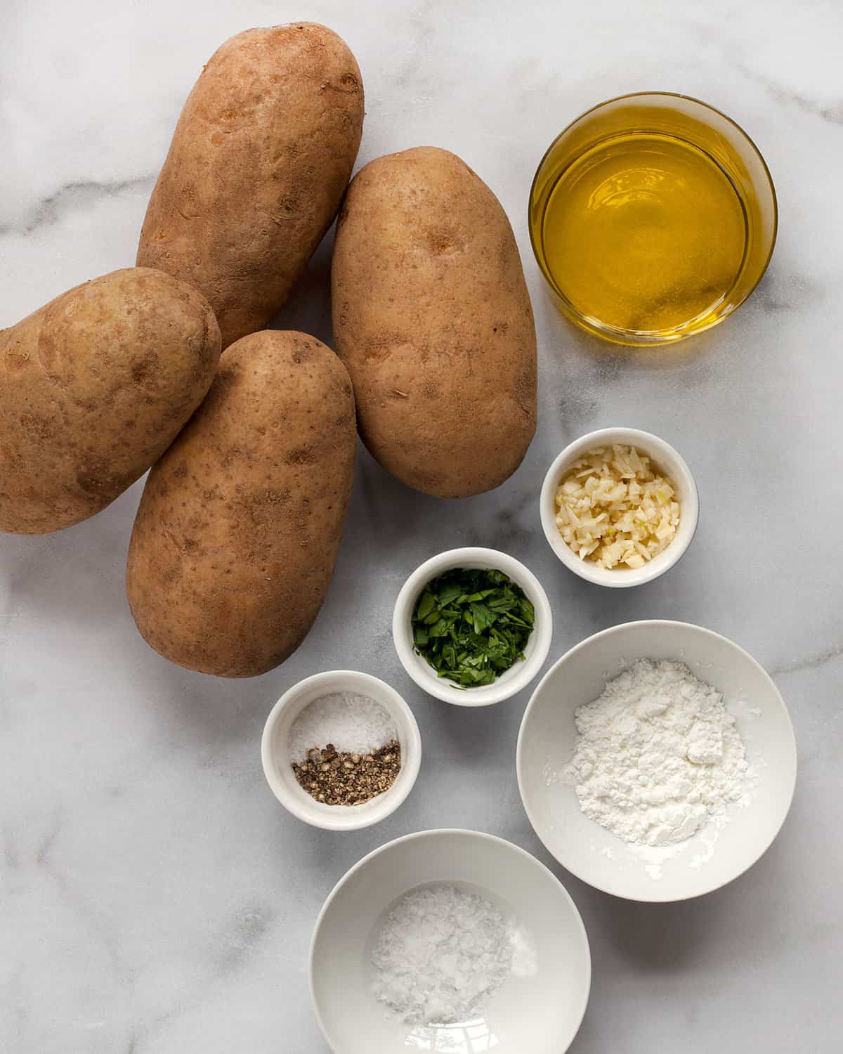 Ingredients including potatoes, oil, seasonings, cornstarch, garlic and parsley.