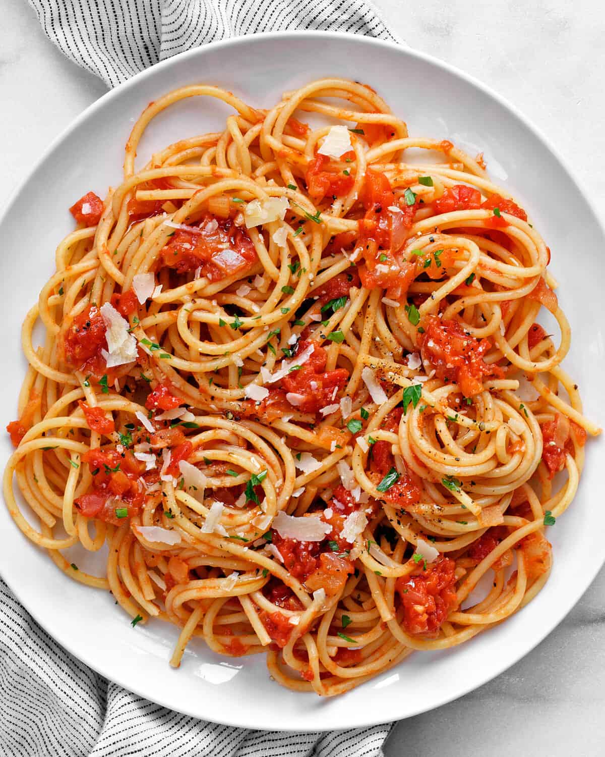 Spaghetti with roma tomato sauce on a plate.