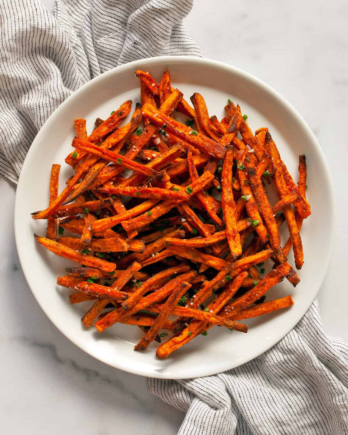 Oven baked sweet potato fries on a plate.