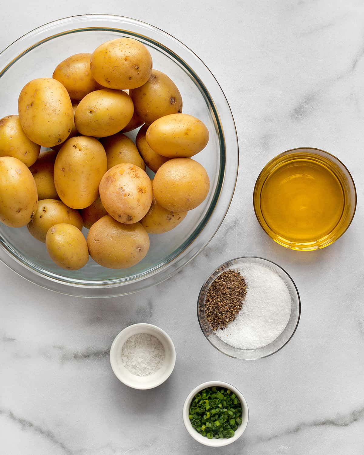 Ingredients including potatoes, olive oil, salt, pepper and chives.