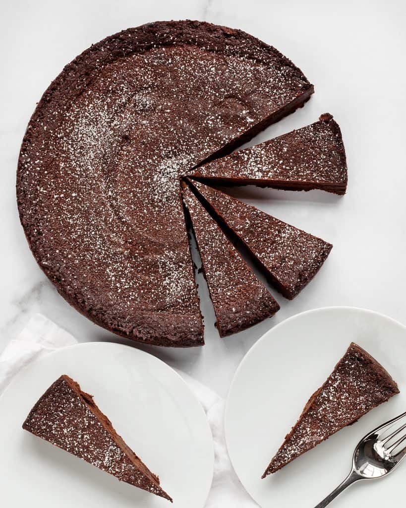 Sliced chocolate cake served on 2 plates