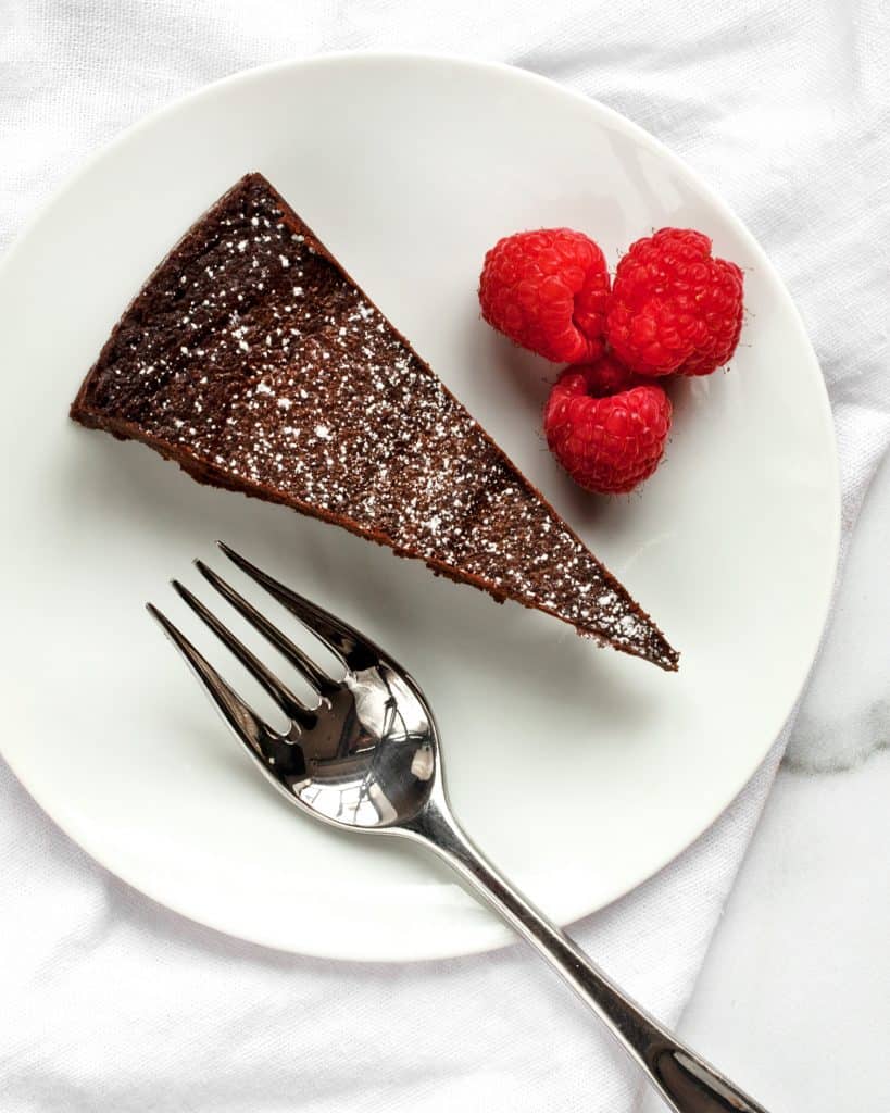Slice of chocolate cake on a plate with berries