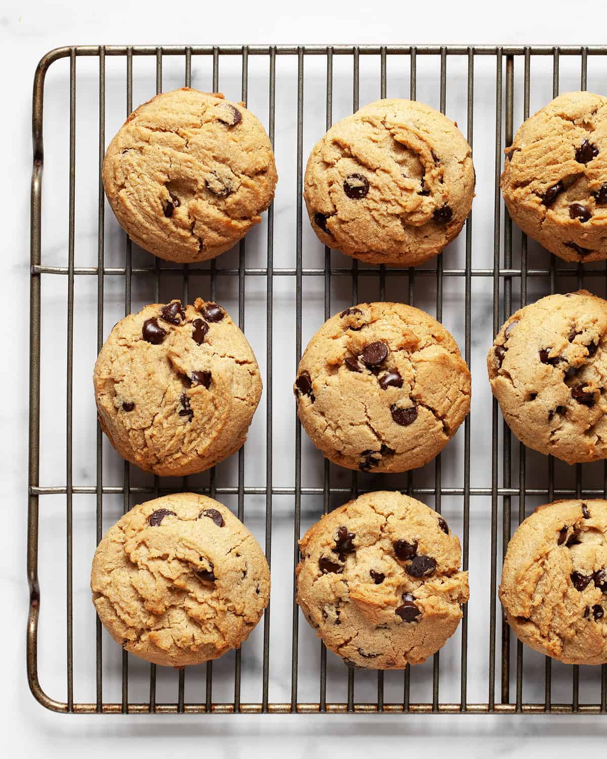 Peanut butter chocolate chaos cookies in rows on a cooling rack.