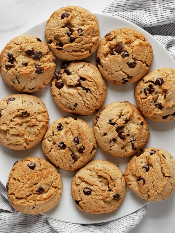 A large plate with peanut butter chocolate chips cookies.