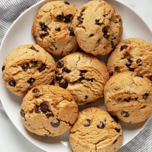 A small plate with peanut butter cookies with chocolate chips.