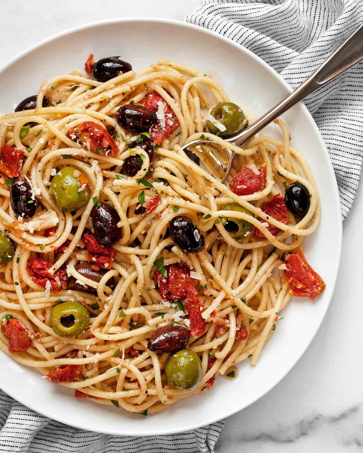 Antipasto pasta on a plate with a fork.