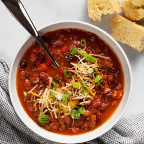 Three bean chili in a bowl with a side of cornbread