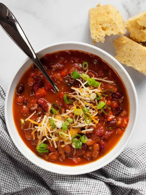 Three bean chili in a bowl with a side of cornbread