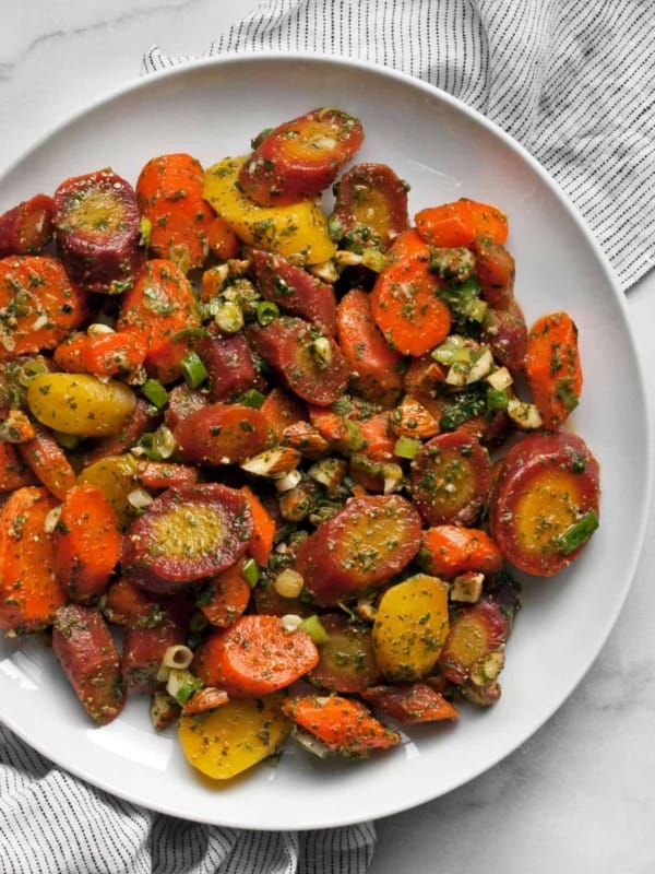 Carrot salad with parsley-cilantro dressing on a plate.