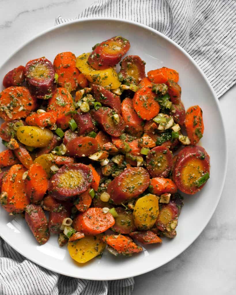 Carrot salad with parsley-cilantro dressing on a plate.