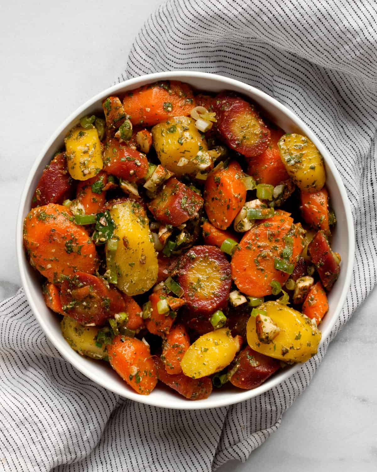 Moroccan carrot salad with almonds and scallions in a bowl.