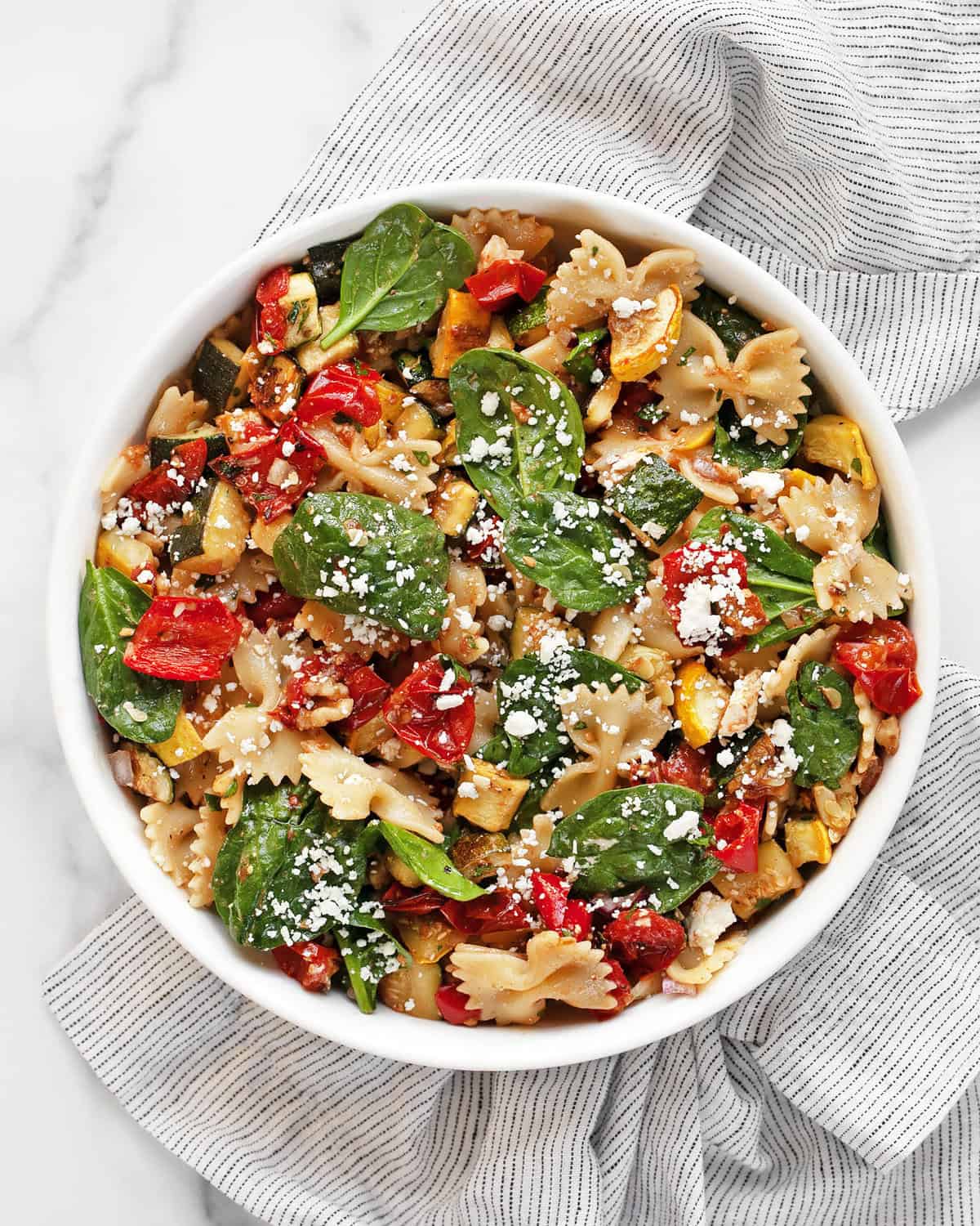 Roasted vegetable bow tie pasta salad in a bowl.