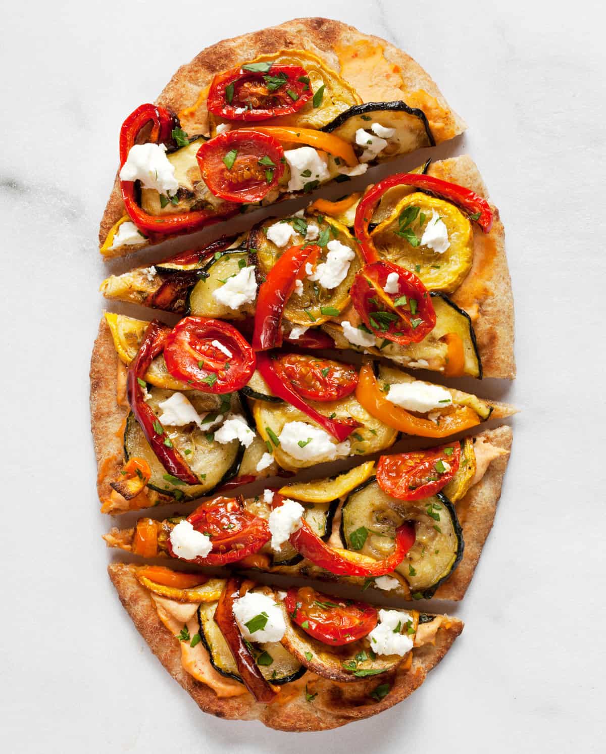 Sliced naan flatbread with vegetables.