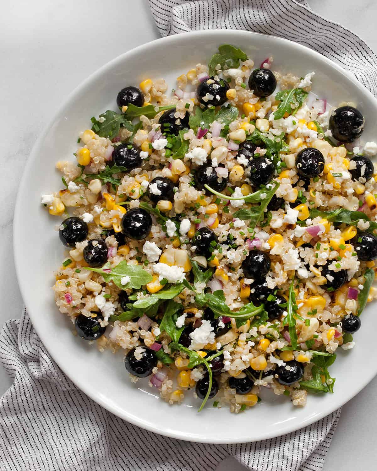 Blueberry salad with corn and quinoa on a plate.