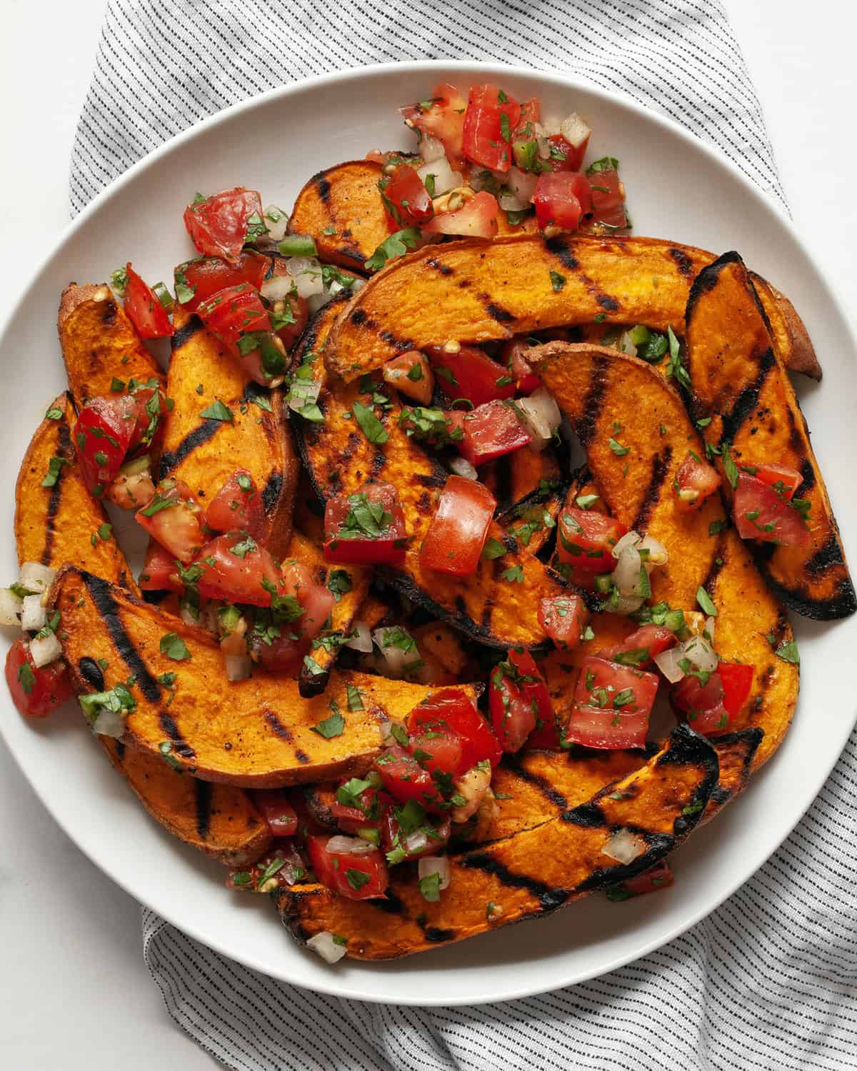 Grilled sweet potatoes topped with pico de gallo.