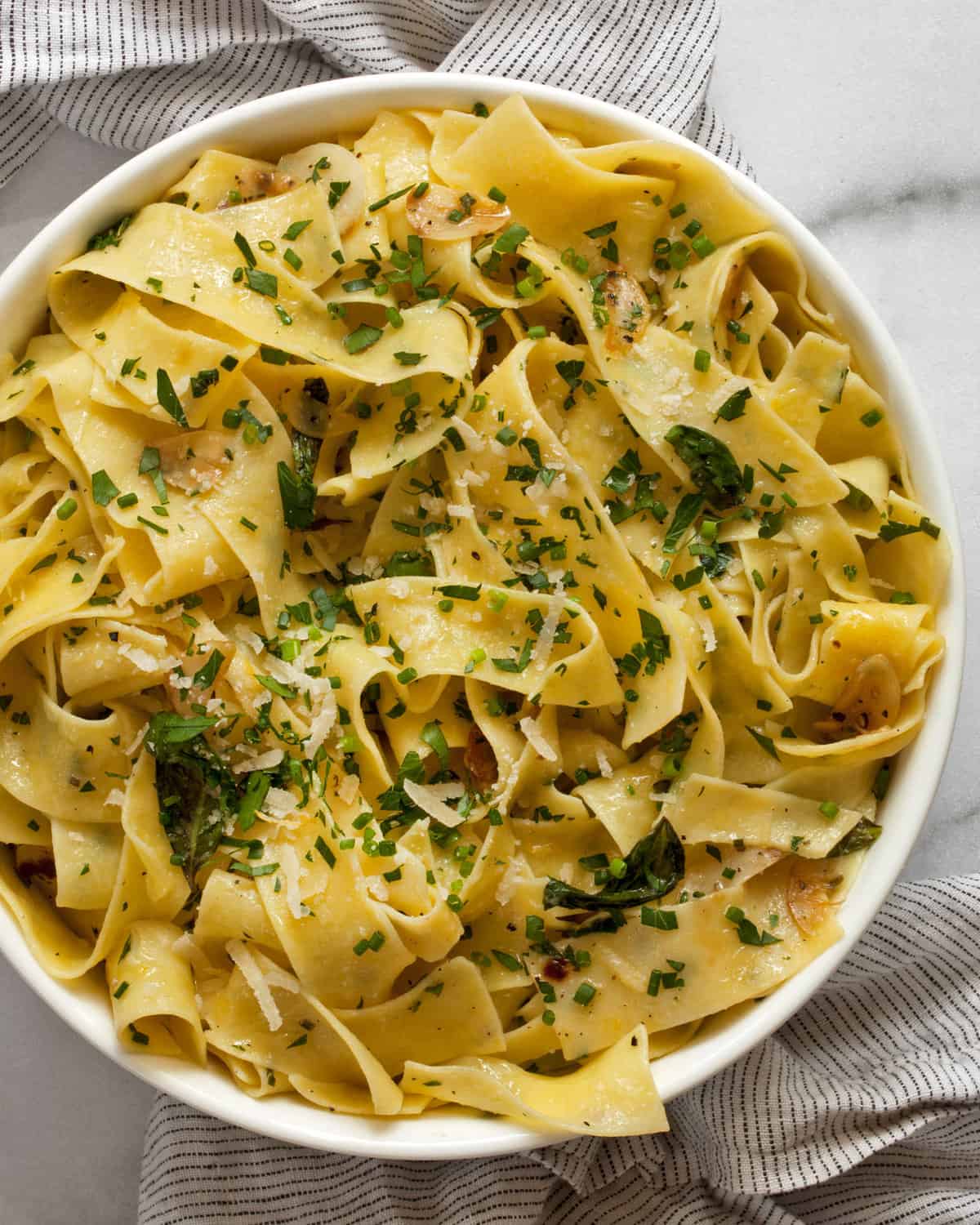 Pappardelle pasta with herbs in a bowl.