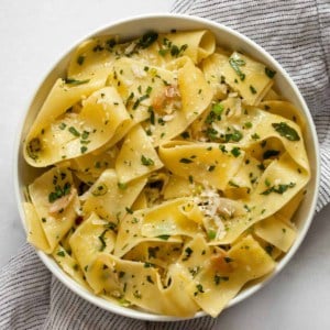 Herb pappardelle pasta in a small bowl.