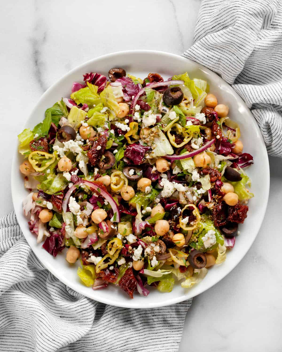 Chopped salad with chickpeas, romaine and radicchio on a plate.