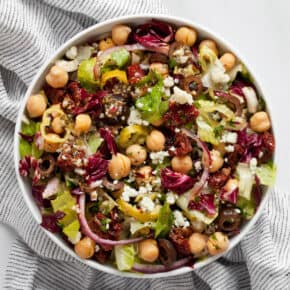 Salad with romaine, radicchio, chickpeas and tomatoes in a bowl.