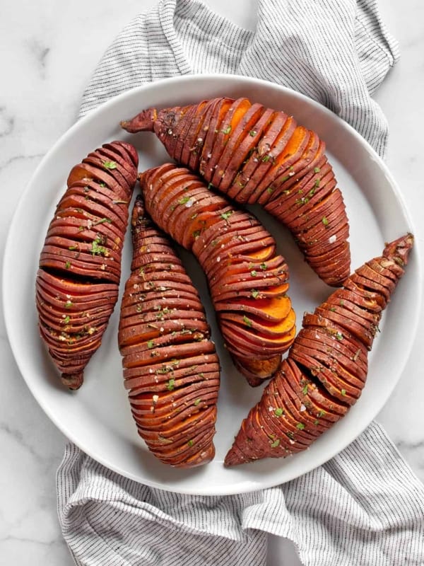 Hasselback sweet potatoes on a plate.