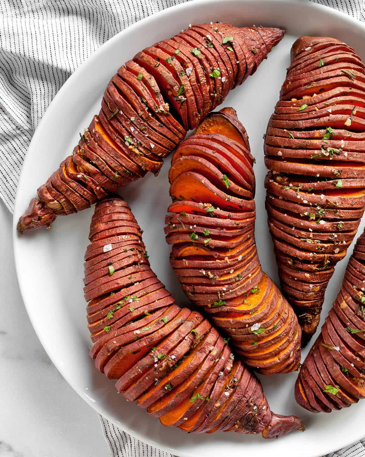 Hasselback potatoes on a plate.