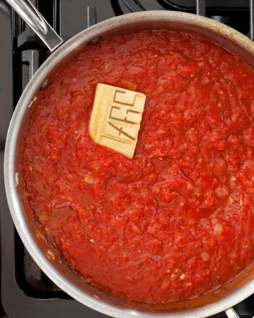 Simmer the tomatoes with a parmesan rind