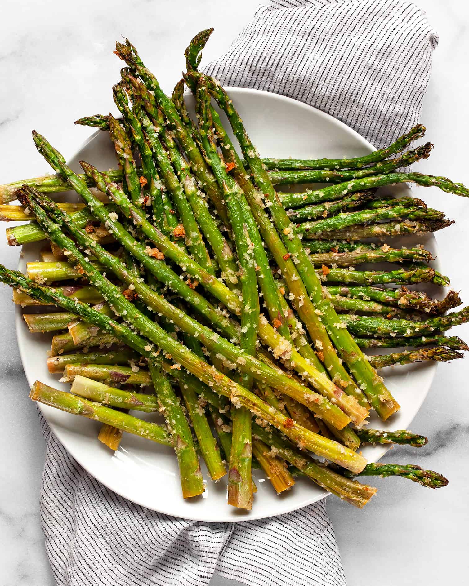 Roasted asparagus with parmesan and garlic on a plate.