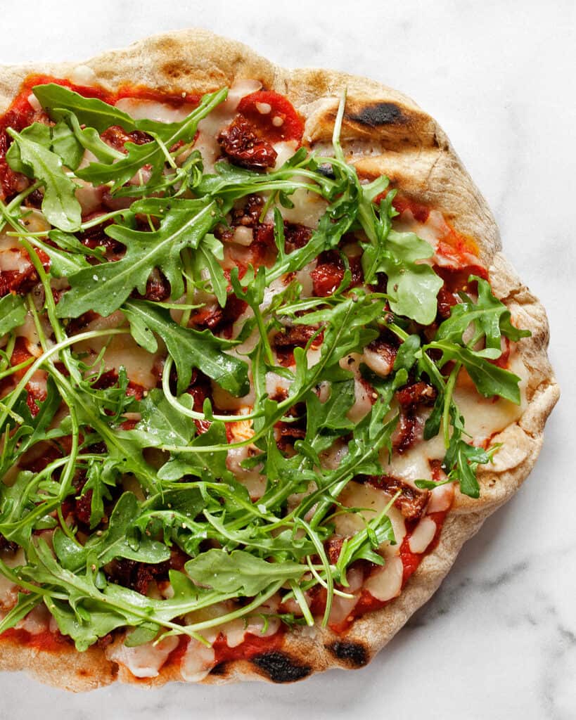 Arugula Pizza with Sun Dried Tomatoes.