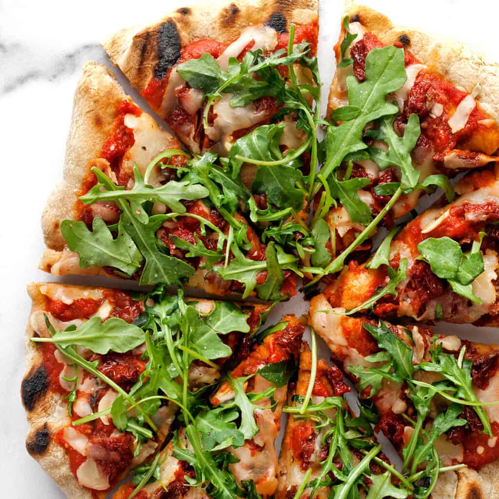 Grilled Arugula Pizza with Sun Dried Tomatoes Last Ingredient