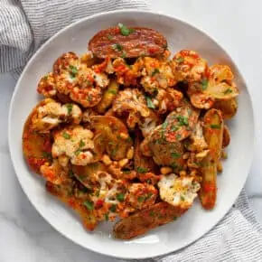 Roasted cauliflower potato salad with red pepper vinaigrette on a plate