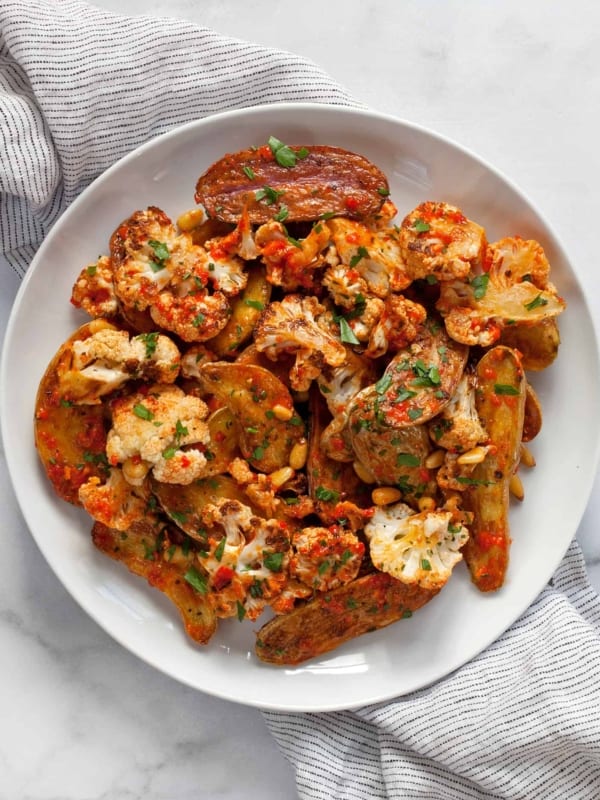 Roasted cauliflower potato salad with red pepper vinaigrette on a plate