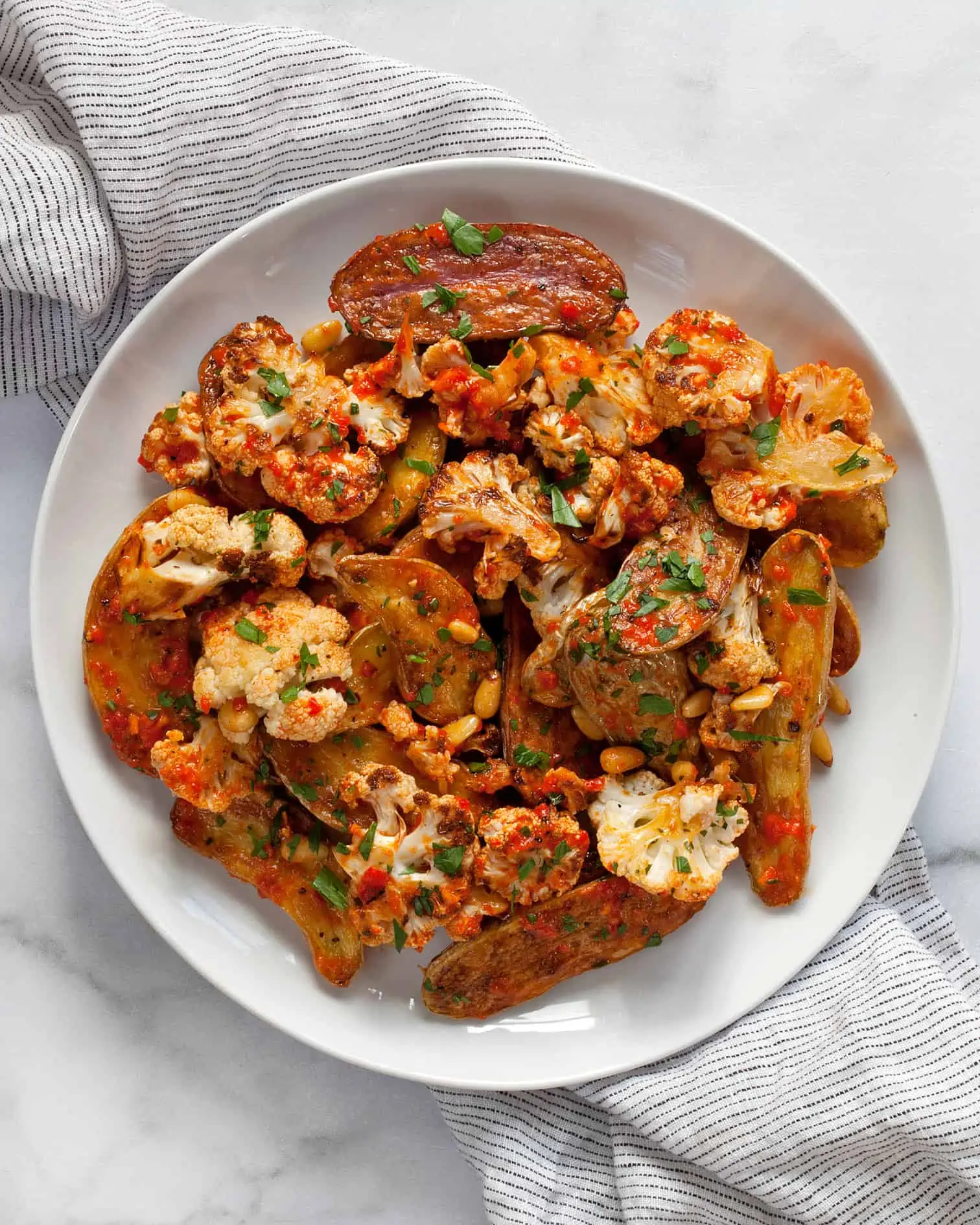 Roasted cauliflower potato salad with red pepper vinaigrette on a plate