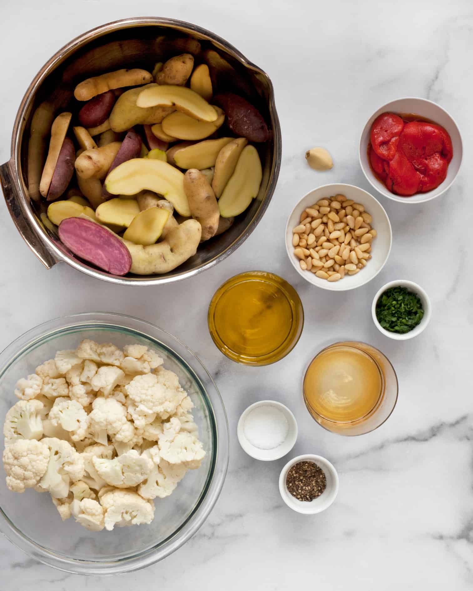 Ingredients including fingerling potatoes, cauliflower and roasted red peppers