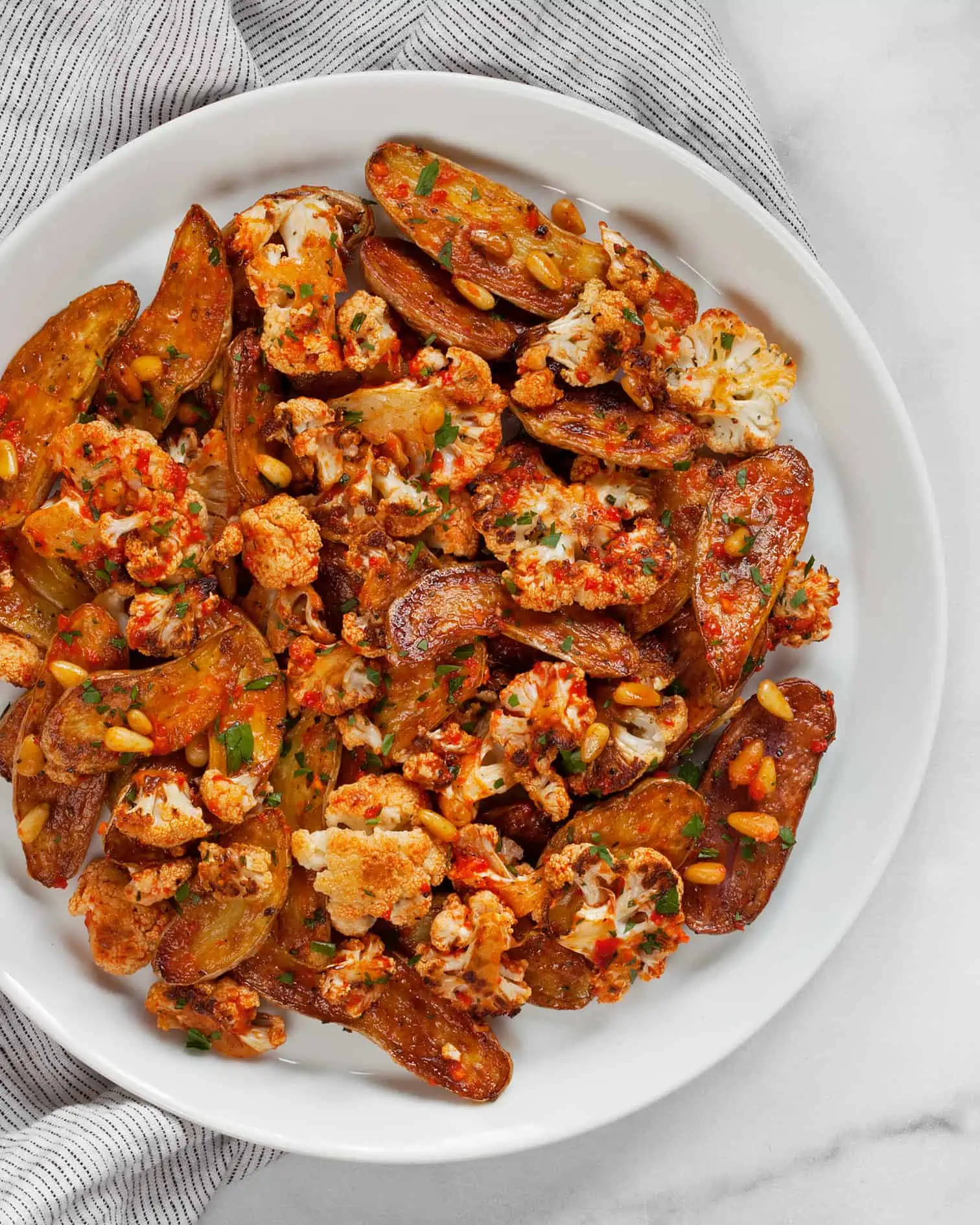 Cauliflower potato salad with red pepper vinaigrette on a plate